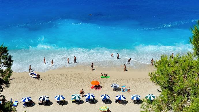 group of people swimming on beach